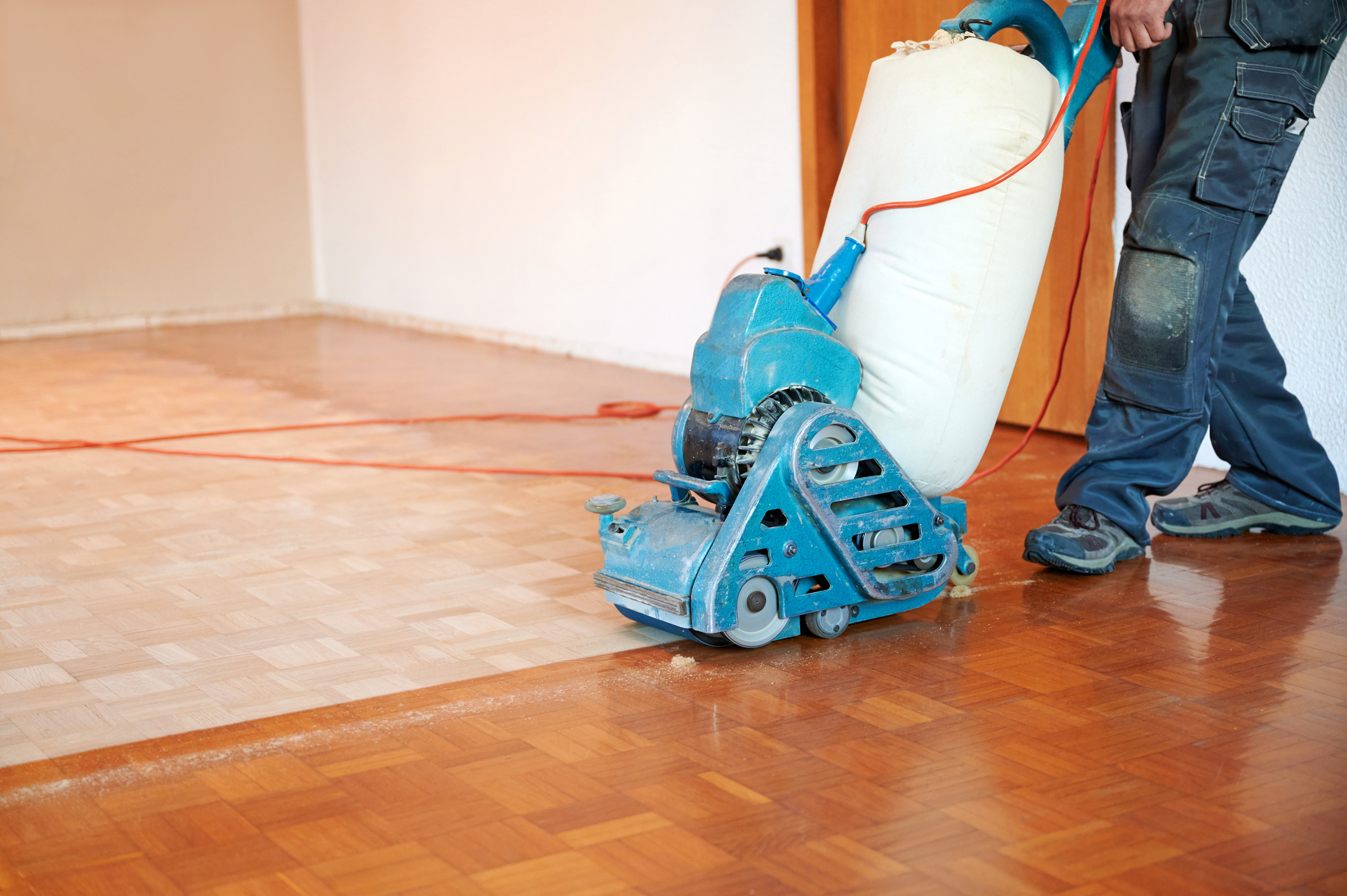 Sanding the wood floor for refinishing